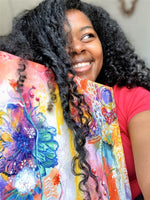 Martice Smith with a custom-painted floral painting on canvas.